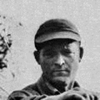 Jimmy Warren Old photo of an unsmiling man in a baseball cap